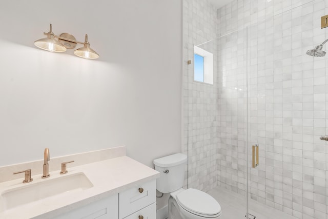 bathroom with toilet, an enclosed shower, and vanity