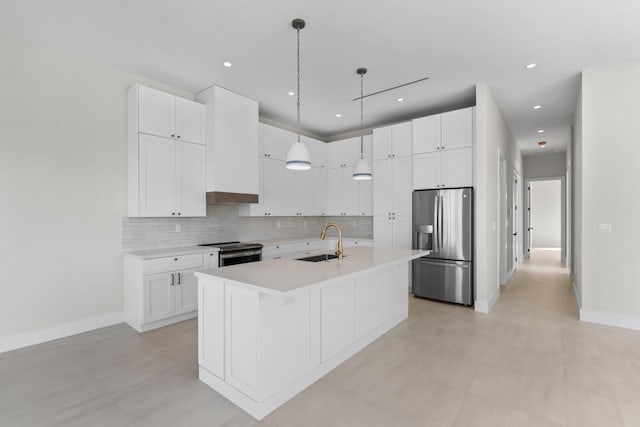 kitchen with appliances with stainless steel finishes, sink, and white cabinets