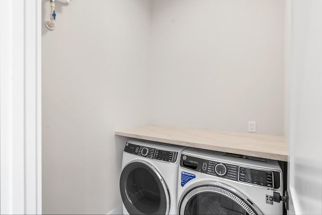 clothes washing area featuring washer and dryer