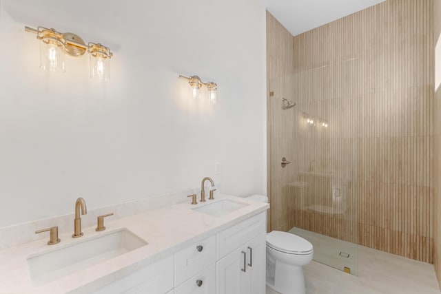 bathroom with toilet, vanity, and a tile shower