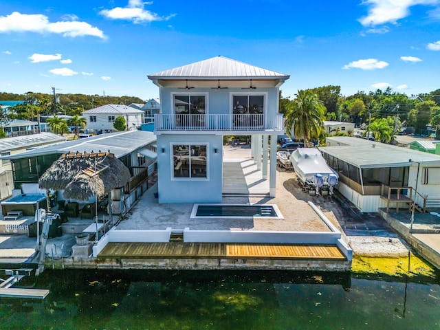 rear view of property featuring ceiling fan