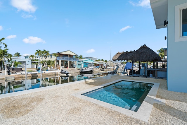 view of pool featuring a water view and a gazebo