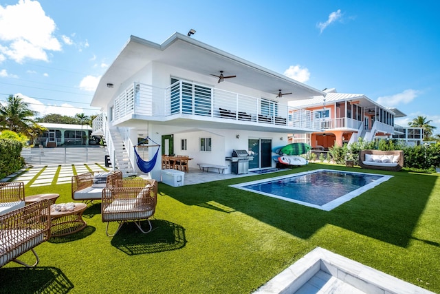 back of house featuring a yard, an outdoor hangout area, ceiling fan, and a patio area