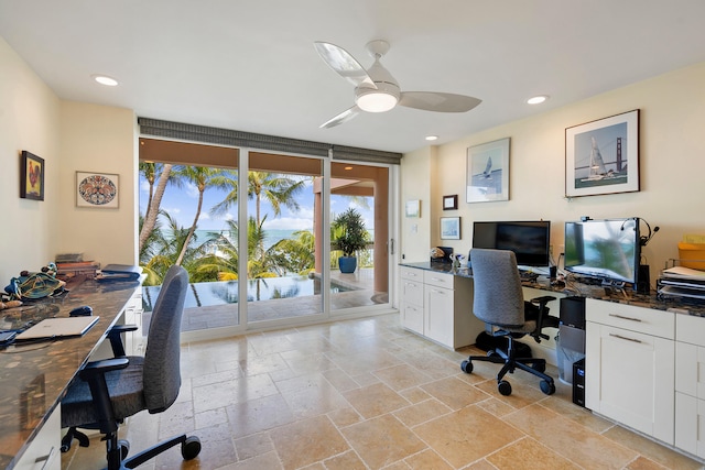 office area featuring ceiling fan, floor to ceiling windows, stone tile flooring, and recessed lighting