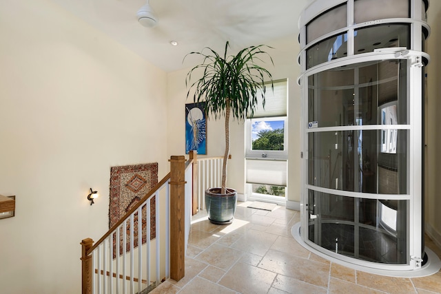 entryway with baseboards and stone tile floors