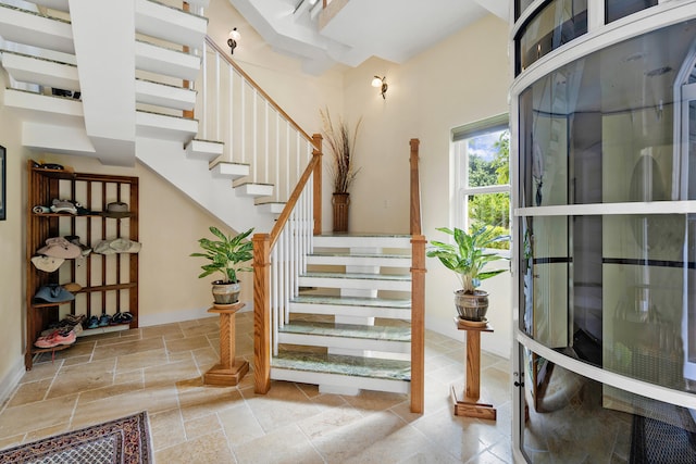 staircase with stone tile floors