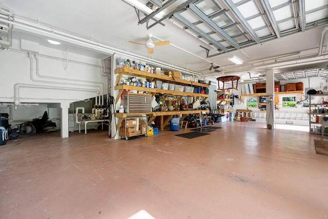 garage featuring a ceiling fan and a workshop area