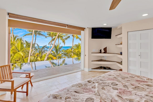 bedroom featuring access to exterior, recessed lighting, and stone tile floors