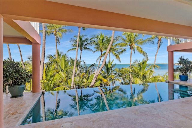 view of swimming pool featuring a water view