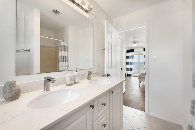 bathroom with ceiling fan, tile patterned floors, vanity, and a shower with shower curtain