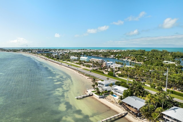 aerial view with a water view and a beach view