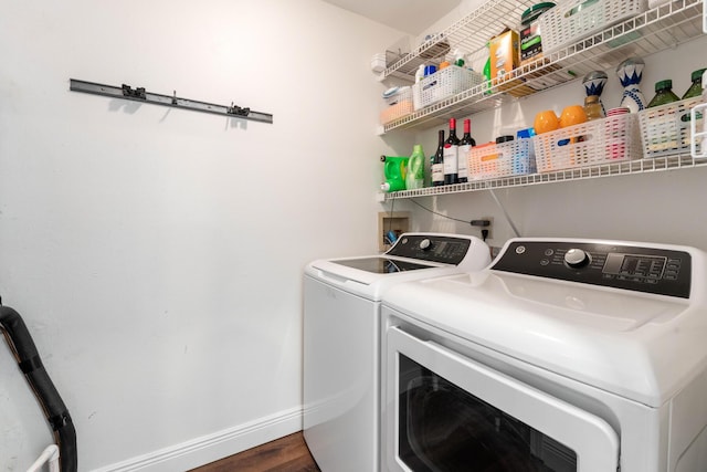 laundry room featuring dark hardwood / wood-style flooring and washer and clothes dryer