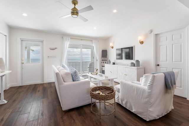 living room with ceiling fan and dark hardwood / wood-style floors