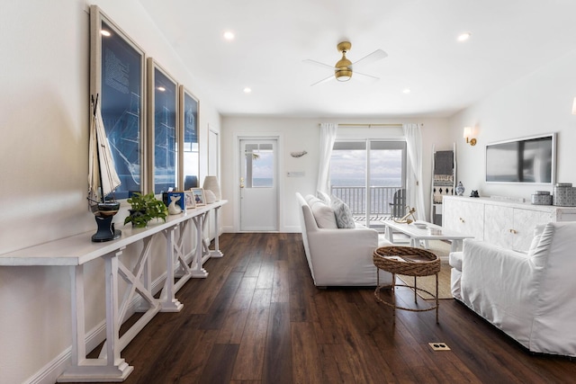 living room with ceiling fan and dark hardwood / wood-style flooring