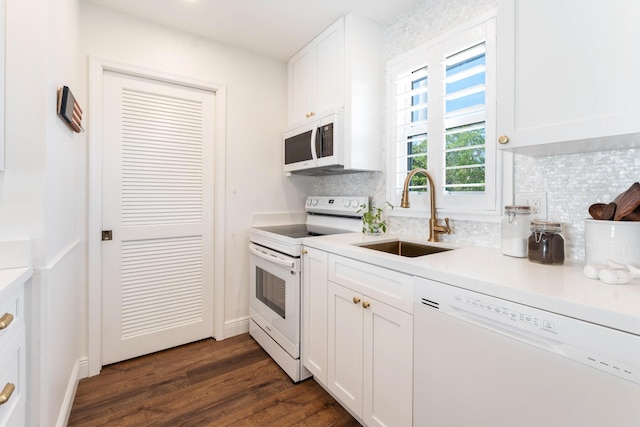 kitchen with sink, white appliances, dark hardwood / wood-style floors, white cabinets, and decorative backsplash