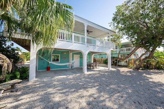 22738 Blackbeard Ln, Cudjoe, FL 33042 - rear view of property featuring ceiling fan, a patio, a carport, and a balcony