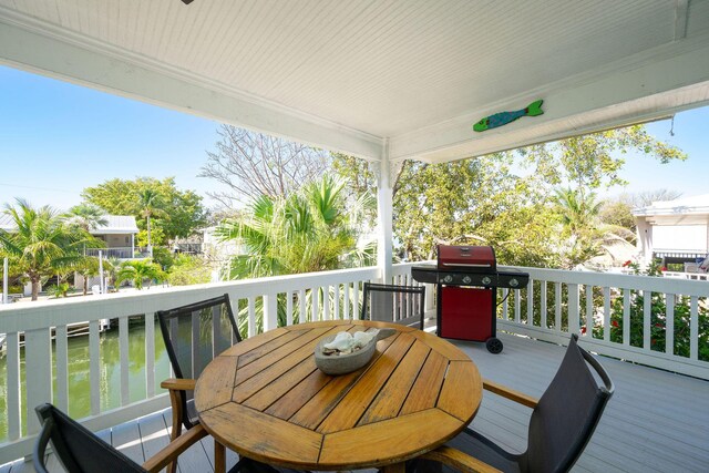 22738 Blackbeard Ln, Cudjoe, FL 33042 - deck featuring a grill, outdoor dining space, and a water view