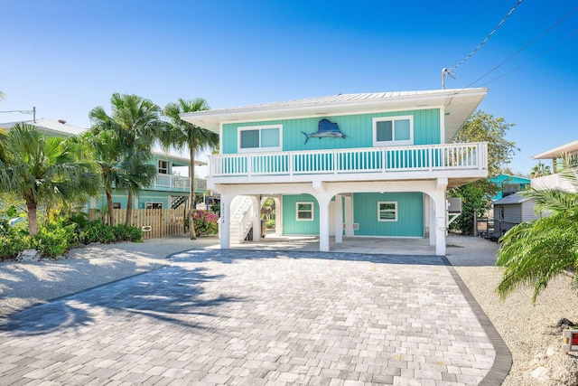 22738 Blackbeard Ln, Cudjoe, FL 33042 - coastal home with a carport, decorative driveway, and metal roof