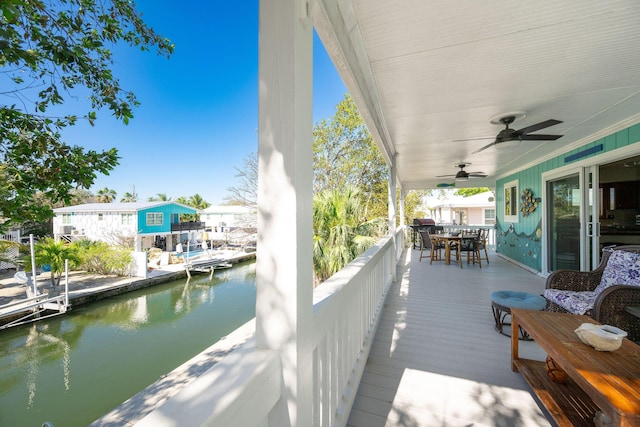 22738 Blackbeard Ln, Cudjoe, FL 33042 - wooden terrace with outdoor dining space, a water view, and ceiling fan