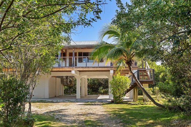 back of house featuring a carport