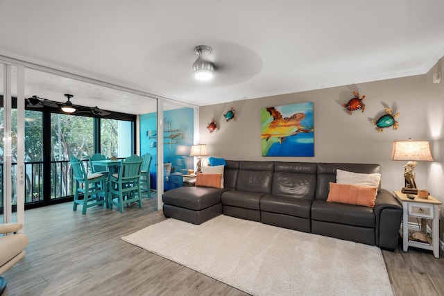 living room with expansive windows, ornamental molding, hardwood / wood-style flooring, and ceiling fan