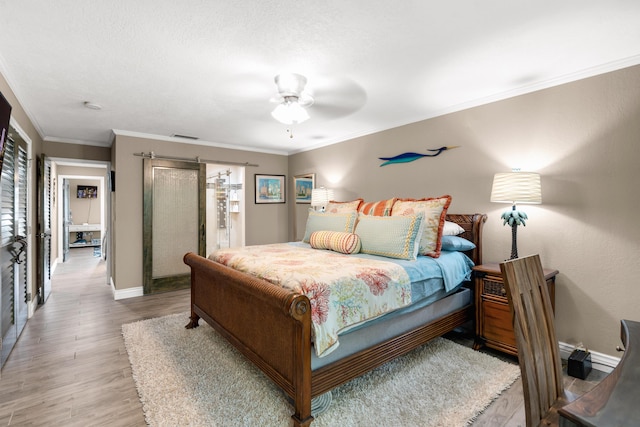 bedroom featuring crown molding, hardwood / wood-style floors, and ceiling fan