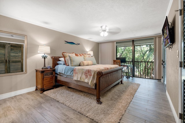 bedroom with crown molding, access to exterior, a textured ceiling, and light wood-type flooring