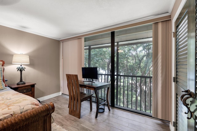 bedroom featuring wood-type flooring, ornamental molding, and a wall of windows