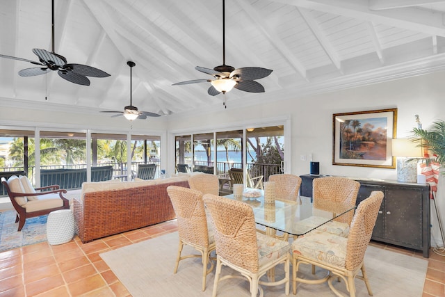 dining room featuring light tile patterned floors, beamed ceiling, and a healthy amount of sunlight