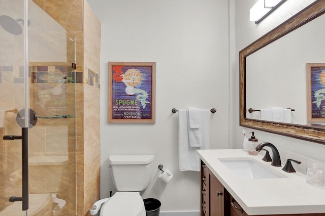 bathroom featuring vanity, toilet, and a shower with shower door