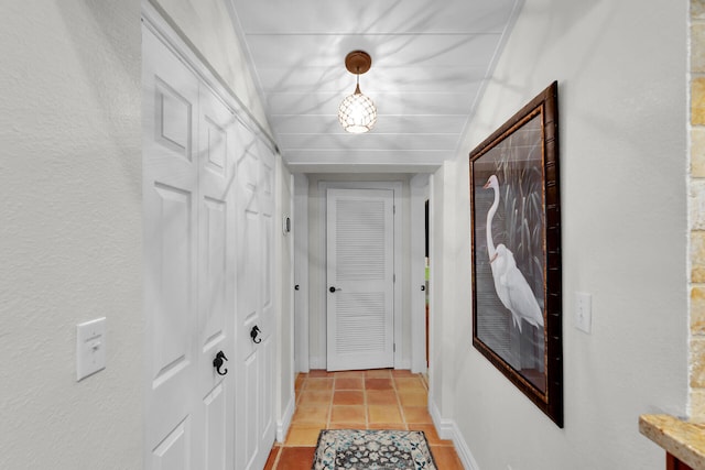 corridor featuring light tile patterned floors