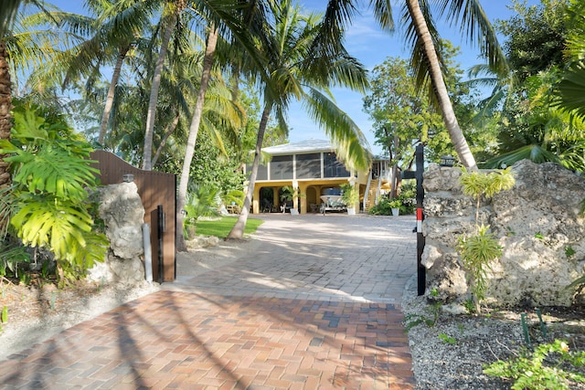 exterior space featuring a sunroom and a carport