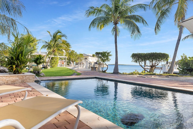 view of swimming pool featuring a water view