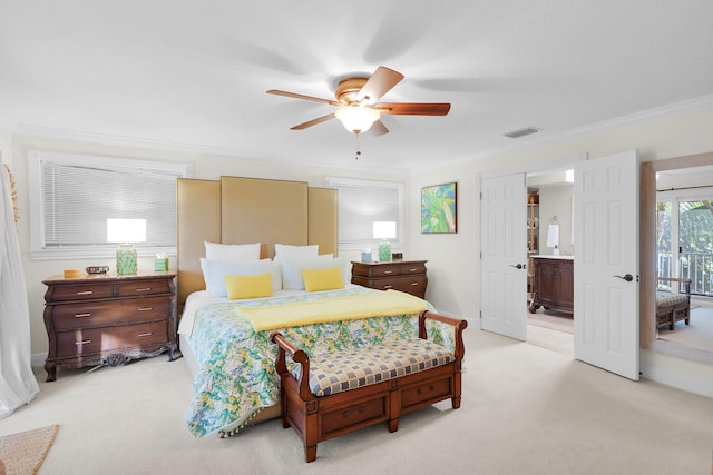 carpeted bedroom featuring ensuite bath, ornamental molding, and ceiling fan