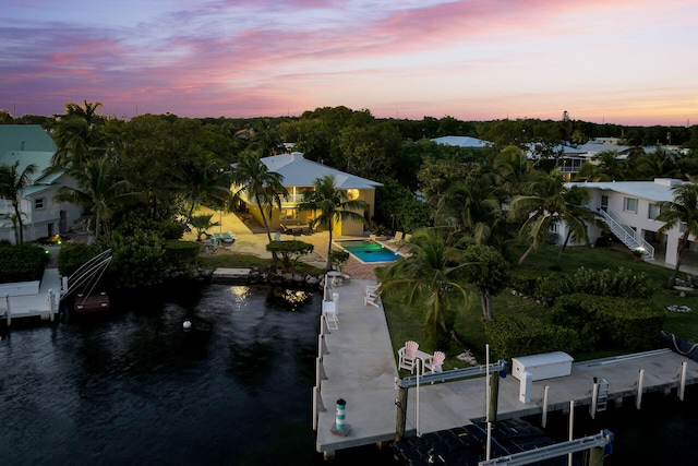 aerial view at dusk with a water view