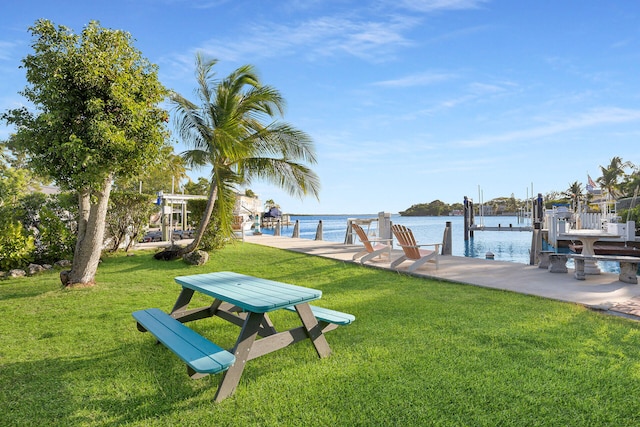 dock area featuring a water view and a lawn