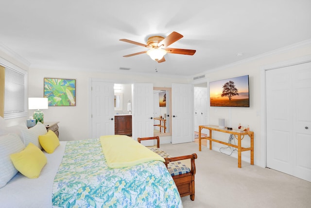 bedroom with ornamental molding, two closets, light colored carpet, and ceiling fan