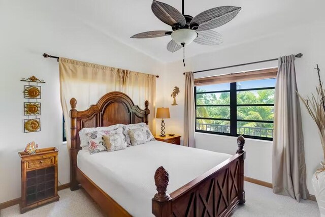 bedroom featuring light colored carpet and ceiling fan