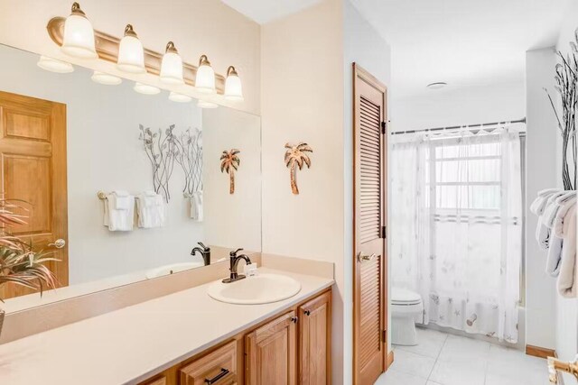 full bathroom with shower / bath combination with curtain, vanity, tile patterned floors, and toilet