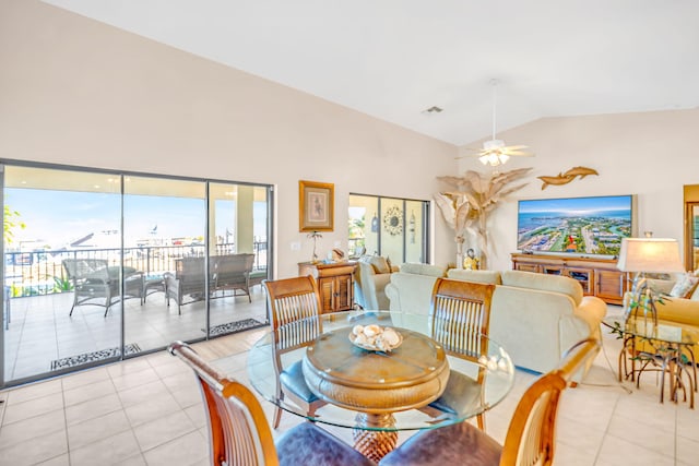 dining room featuring vaulted ceiling, light tile patterned floors, and ceiling fan