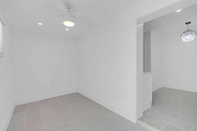 unfurnished room with baseboards and recessed lighting