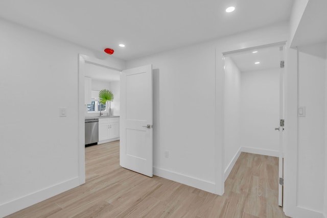 unfurnished room featuring recessed lighting, baseboards, and light wood finished floors