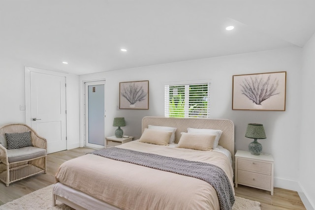 bedroom featuring baseboards, light wood-type flooring, and recessed lighting