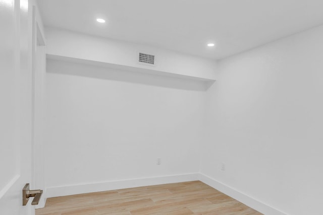 empty room featuring recessed lighting, wood finished floors, visible vents, and baseboards