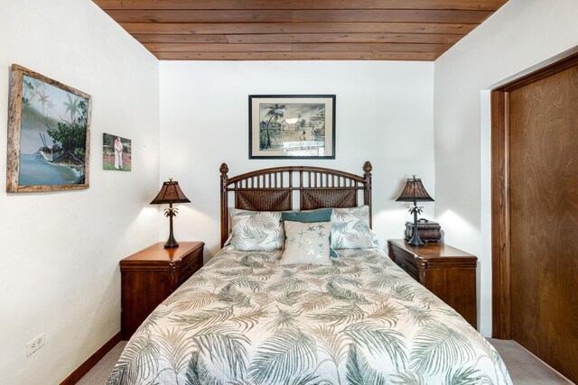 bedroom featuring wooden ceiling and carpet flooring