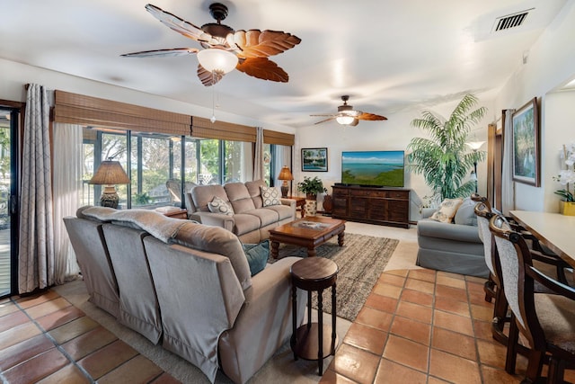 tiled living area featuring visible vents and a ceiling fan