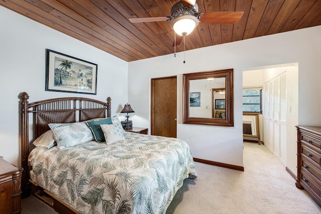 bedroom with wooden ceiling, light colored carpet, ceiling fan, and baseboards