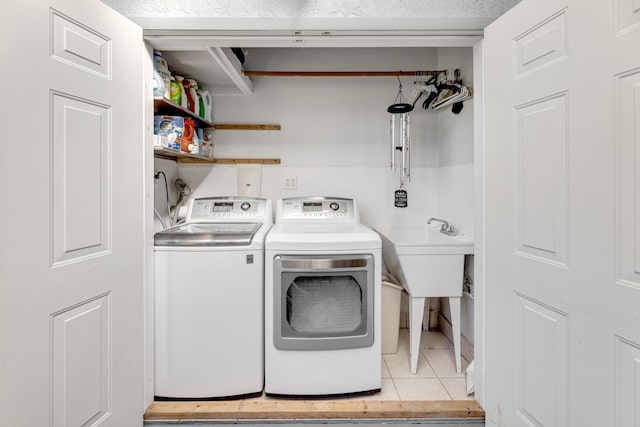 laundry room with laundry area, tile patterned flooring, and washing machine and clothes dryer