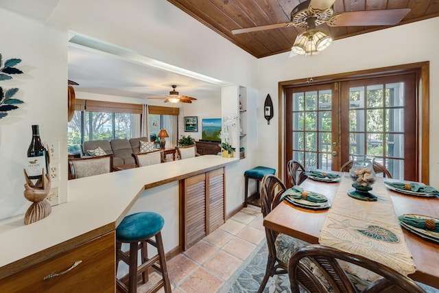 dining area with french doors, wood ceiling, light tile patterned flooring, ceiling fan, and baseboards