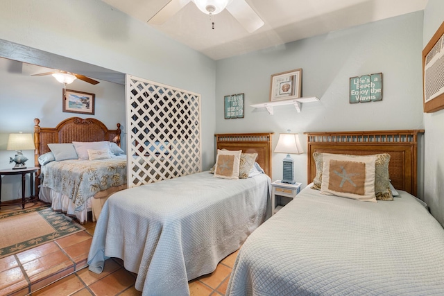 bedroom with a ceiling fan and light tile patterned flooring